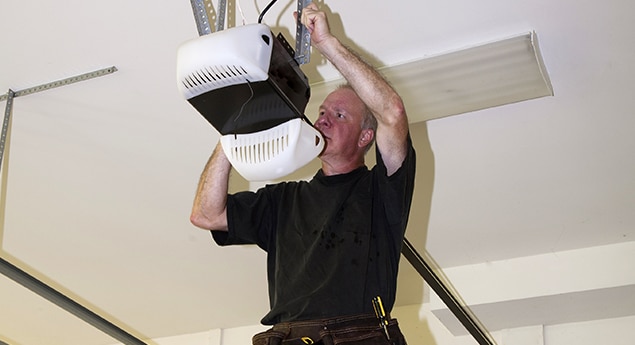 a guy repairing garage door opener